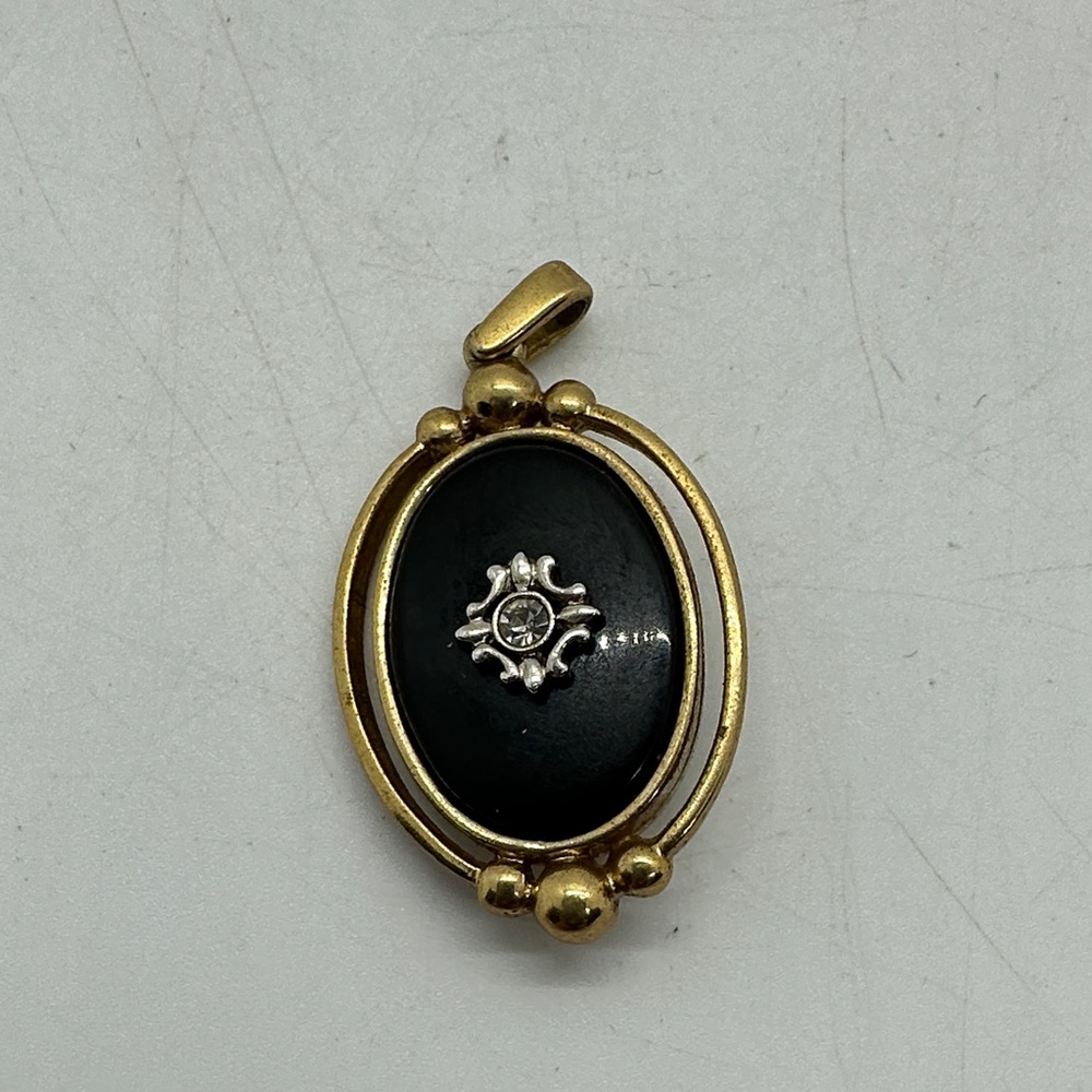 Gold-Tone Black Oval Pendant with Decorative Accent